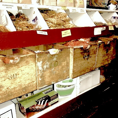 Wooden bins and drawers under the counter, numbered. They used to hold 8-, 10-, and 12-penny nails. Today they hold trail snacks and dried fruit.